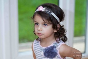 Pink satin rose with guinea feather and rhinestone bow