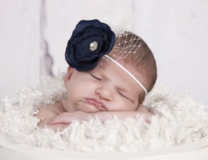 Layered navy satin flower with rhinestone, feather and net on a soft elastic headband