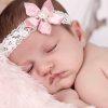 Delicate dusky pink satin flower on an ivory lace headband