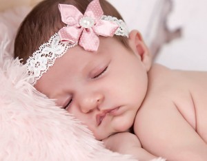 Delicate dusky pink satin flower on an ivory lace headband
