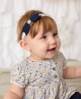 Felt navy bow decorated with sparkly rhinestone on a delicate soft elastic headband