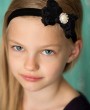 Beautiful black rose chiffon bow decorated with a stunning large rhinestone on a soft elastic headband