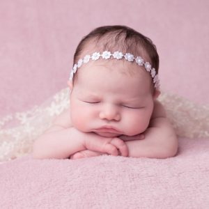Delicate white satin flowers individually decorated with pearls