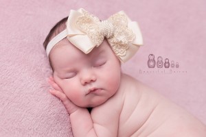 Oversized bow with gold lace and pearls in ivory