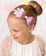 Large pink glitter bow decorated with rhinestone on a satin alice band