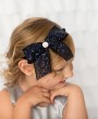 Navy sequin bow decorated with rhinestone on a navy satin alice band