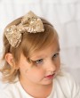 Gold sequin bow on a gold thin alice band