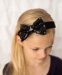 Black sequin bow decorated with Swarovski crystals on a black wide satin alice band