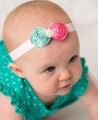 Silk roses in pink and mint decorated with rhinestone on a soft elastic headband