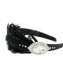 Black goose feathers decorated with Swarovski crystals and diamnate on a satin alice band